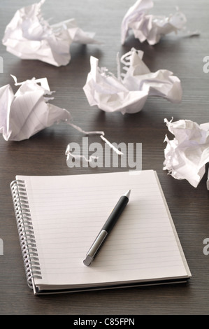 Pen on Notebook with Pages Crumpled Stock Photo