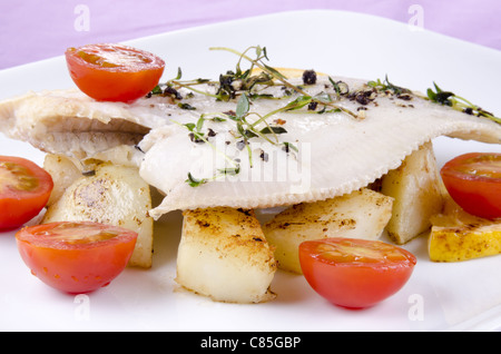 fresh fried plaice with roasted potatoes and tomatoes Stock Photo