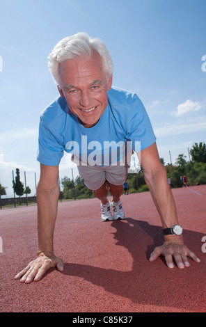 Man Exercising Outdoors on Track Stock Photo