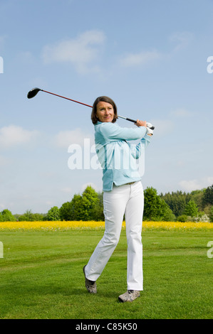 brunette golfer in full length plays golf on a white background Stock ...
