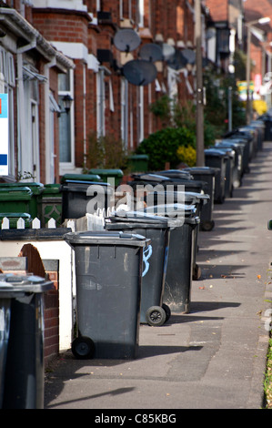a line of full refuse bins waiting for collection Stock Photo
