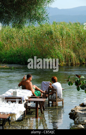 AKYAKA, TURKEY. A couple sitting at a restaurant by (or rather, in) the Azmak river. 2011.