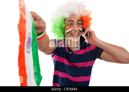 Boy talking on a phone and cheering Stock Photo