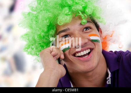 Boy with a wig talking on a mobile phone Stock Photo