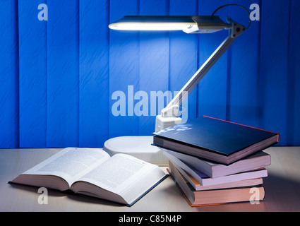 open book and pile books is on desk Stock Photo