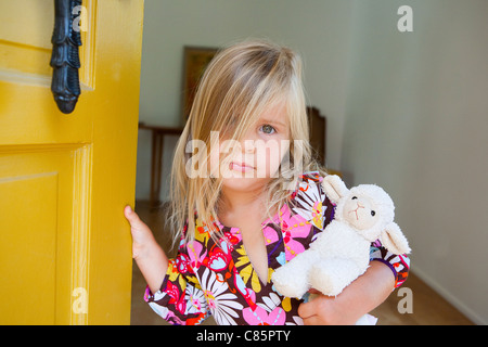 Little girl holding stuffed lamb Stock Photo