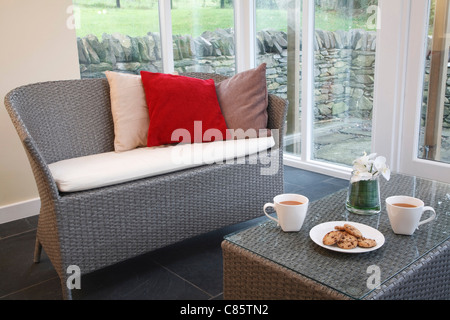 Conservatory interior design with rattan chairs and coffee table Stock Photo