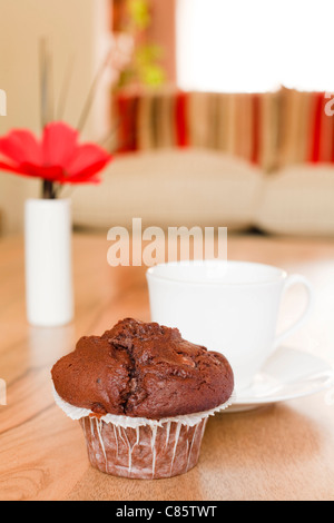 Chocolate muffin on a coffee table in a luxury home interior Stock Photo