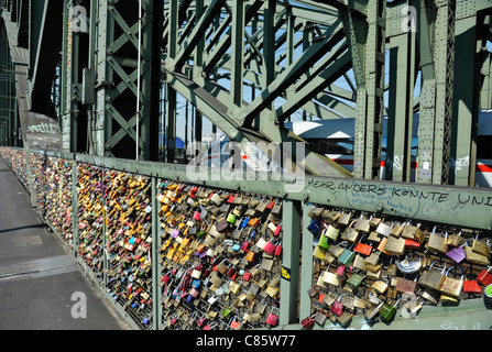 Love Padlocks, or Love Locks affixed to a security fence on Hohenzollern bridge in Cologne, Germany Stock Photo