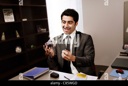 Businessman juggling paper in the office Stock Photo