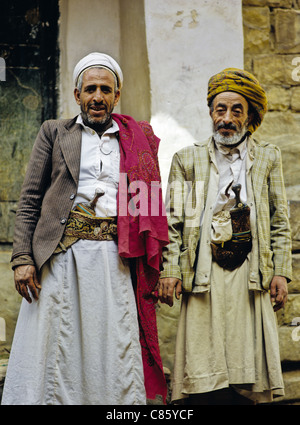 Portrait of two men, both wearing traditional dress/hats; also each ...