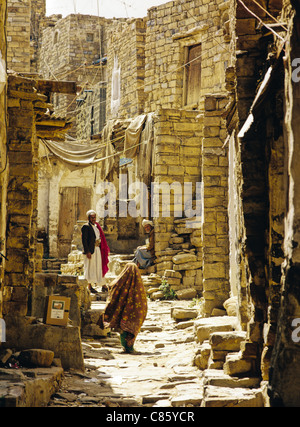 Historic architecture in a narrow street or alley scene in the ancient city of Thula or Thila in the Amran Governorate of Yemen Stock Photo