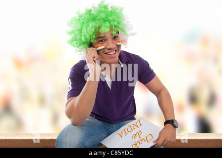 Boy with a wig talking on a mobile phone Stock Photo