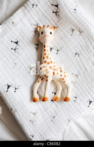 Plastic giraffe toy on baby blanket Stock Photo