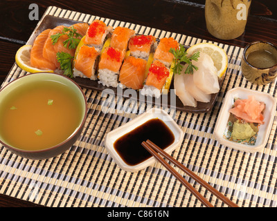 Served sushi rolls, sashimi, miso and sake Stock Photo