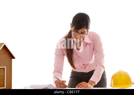 Female engineer making blueprints Stock Photo