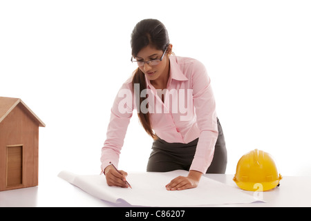 Female engineer making blueprints Stock Photo