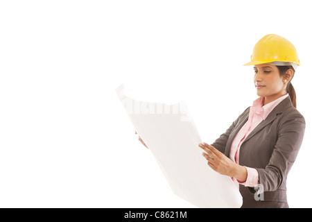 Female engineer reading blueprints Stock Photo