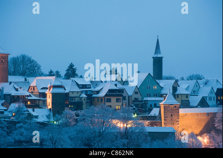 Quaint, snow covered village at night Stock Photo