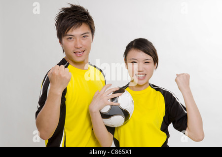 young couple as football players Stock Photo