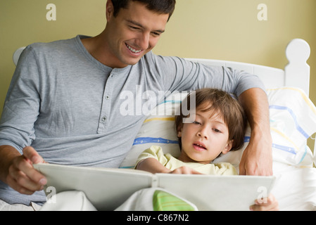 Father and son reading story together