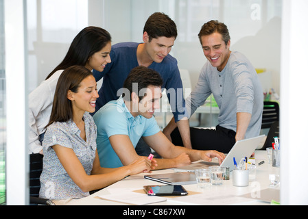 Colleagues working together with laptop computer Stock Photo