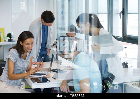 Colleagues collaborating in office Stock Photo