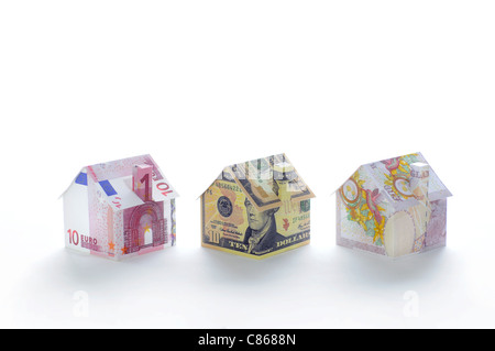 Model houses folded with different currencies Stock Photo