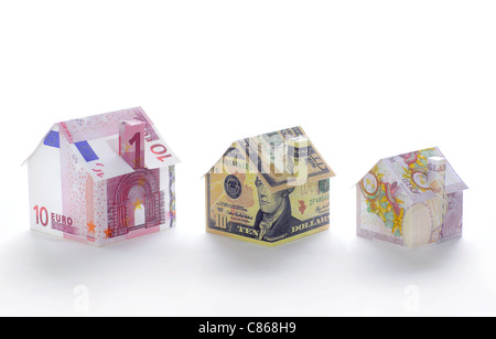 Model houses folded with different currencies Stock Photo