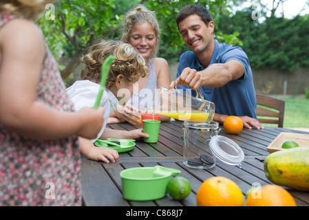 Family enjoying outdoor snack Stock Photo