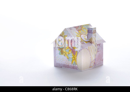 Model house folded with British pound banknote Stock Photo