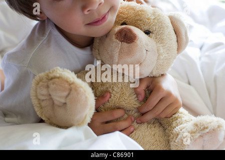 Little boy hugging teddy bear, cropped Stock Photo