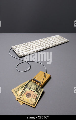 Dollar bill in mousetrap connected to keyboard Stock Photo