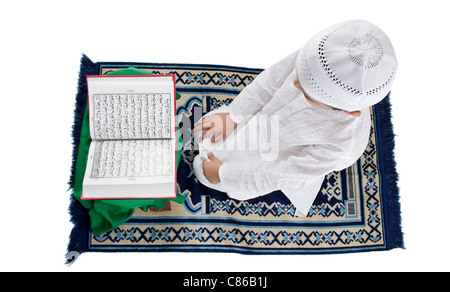 Muslim boy reading the Quran Stock Photo