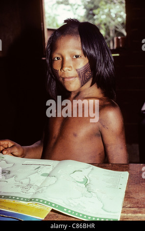 A-ukre village, Brazil. Pidjuri, a Kayapo boy, studying geography in the school; Xingu Indigenous Area, Para state. Stock Photo