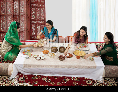 Muslim women having food during Id