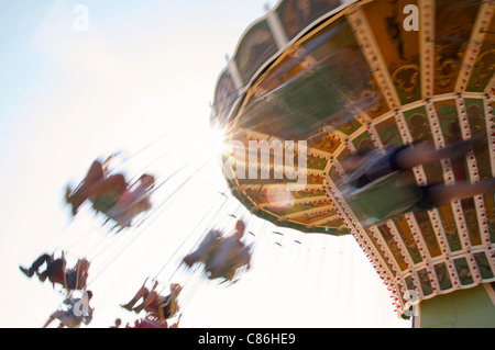People having fun on a retro chairoplane at a fair Stock Photo