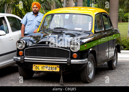 Sikh taxi driver with classic Ambassador taxi at The Imperial Hotel, New Delhi, India Stock Photo