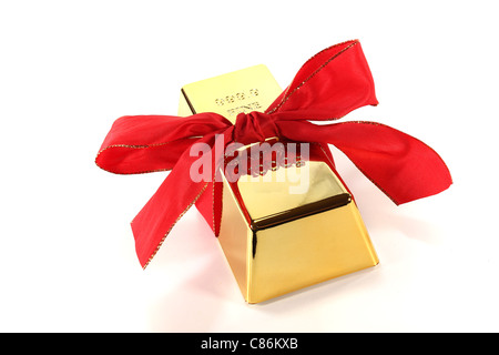 Gold bars with red bow on a white background Stock Photo