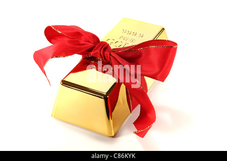 Gold bars with red bow on a white background Stock Photo