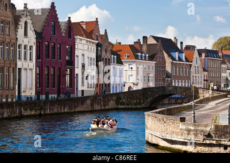 Tourist boat on the canal along the Spinolarei and Spiegelrei in Bruges,(Brugge), Belgium Stock Photo