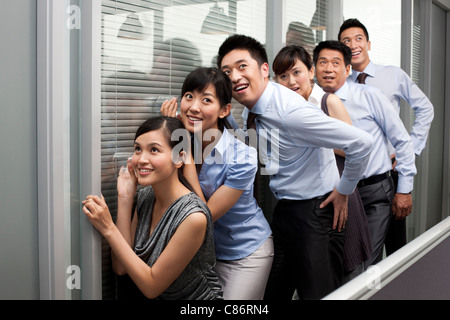 Colleagues Holding Glasses Against the Wall