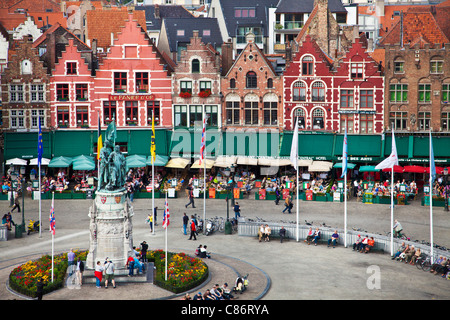 View from Belfry of the statue, cafes, restaurants and tourists in the Grote Markt or Market Square in Bruges, (Brugge), Belgium Stock Photo