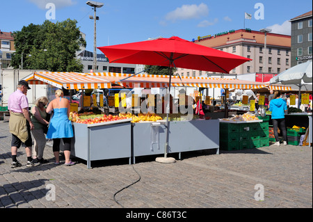 A busy market day in the Market Square of Turku town. The vegetable and fruit stalls are full of fresh products and the square.. Stock Photo