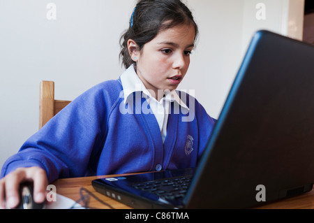 Schoolgirl,9,working on a computer Stock Photo