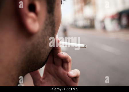 Young man smoking a cigarette Stock Photo