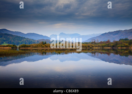 Elterwater in the Lake District with a view of the Langdale Pikes reflected in the water Stock Photo