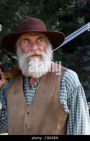 A cowboy holding a rifle Stock Photo