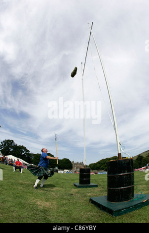 Jamie Barr from Fife in Scotland pitches the sheaf at the Glenarm Castle International Highland Games USA v Europe, Glenarm, County Antrim, Northern Ireland. Stock Photo