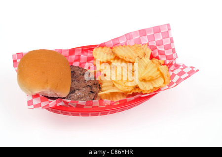 Grilled hamburger with bread roll with potato chips or crisps in red plastic  retro basket on white background, isolate. USA Stock Photo